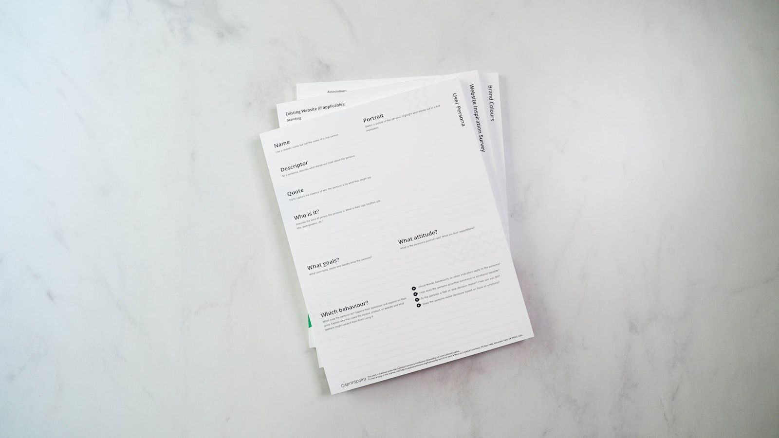 A stack of printed documents on a bright marble surface