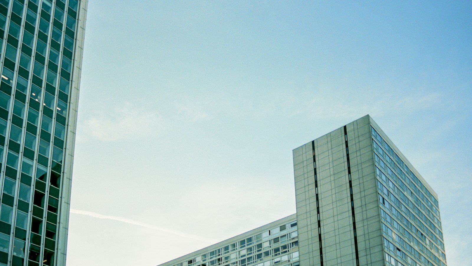Modern glass office buildings against a blue sky