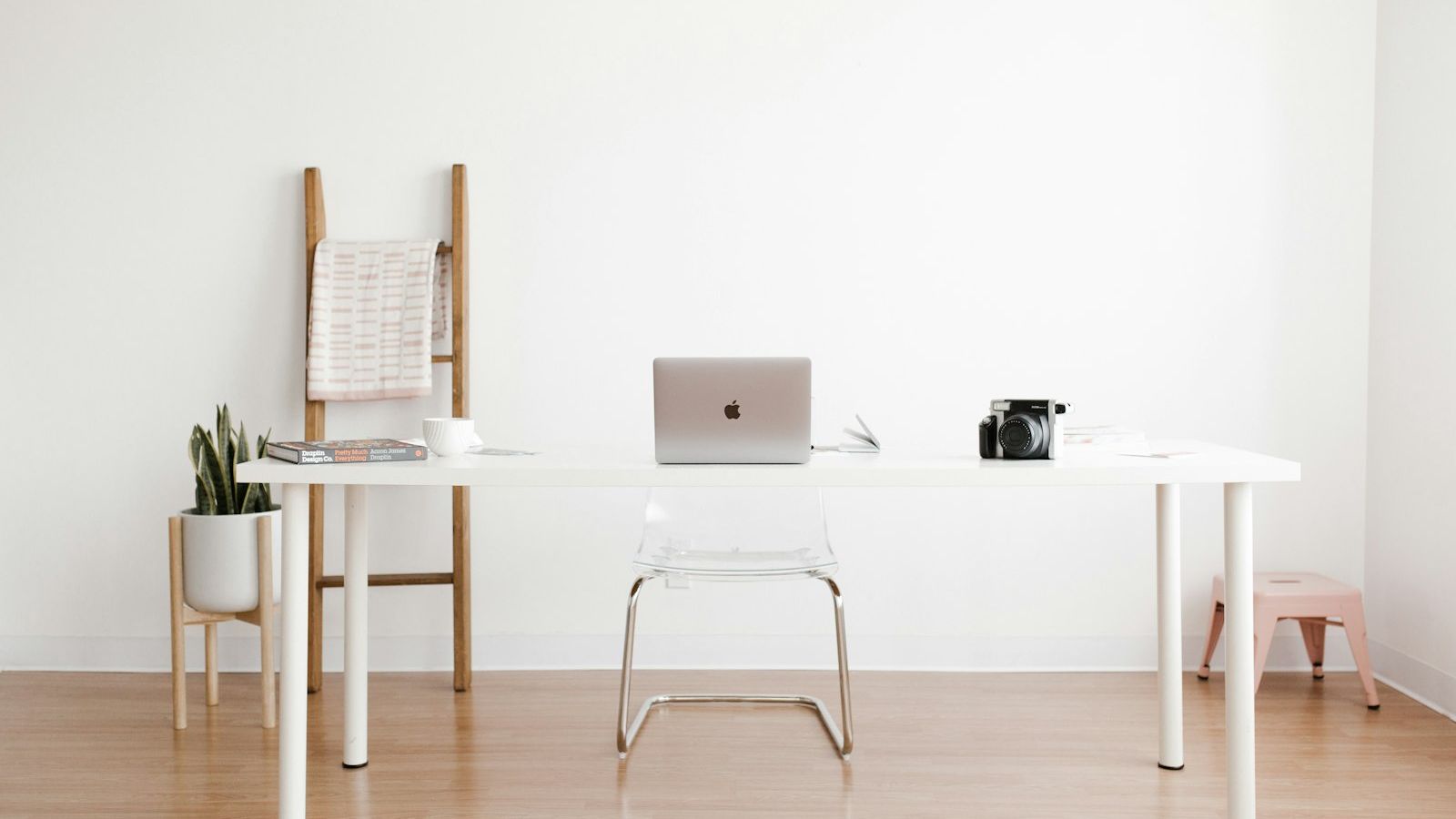 Bright, tidy workstation with desk and laptop