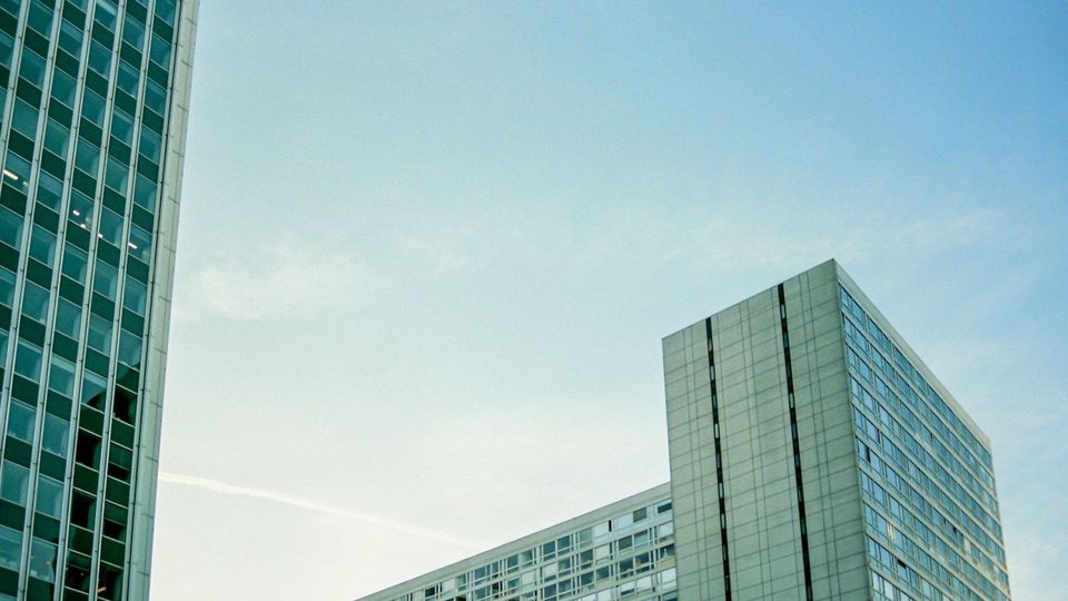 Modern glass office buildings against a blue sky