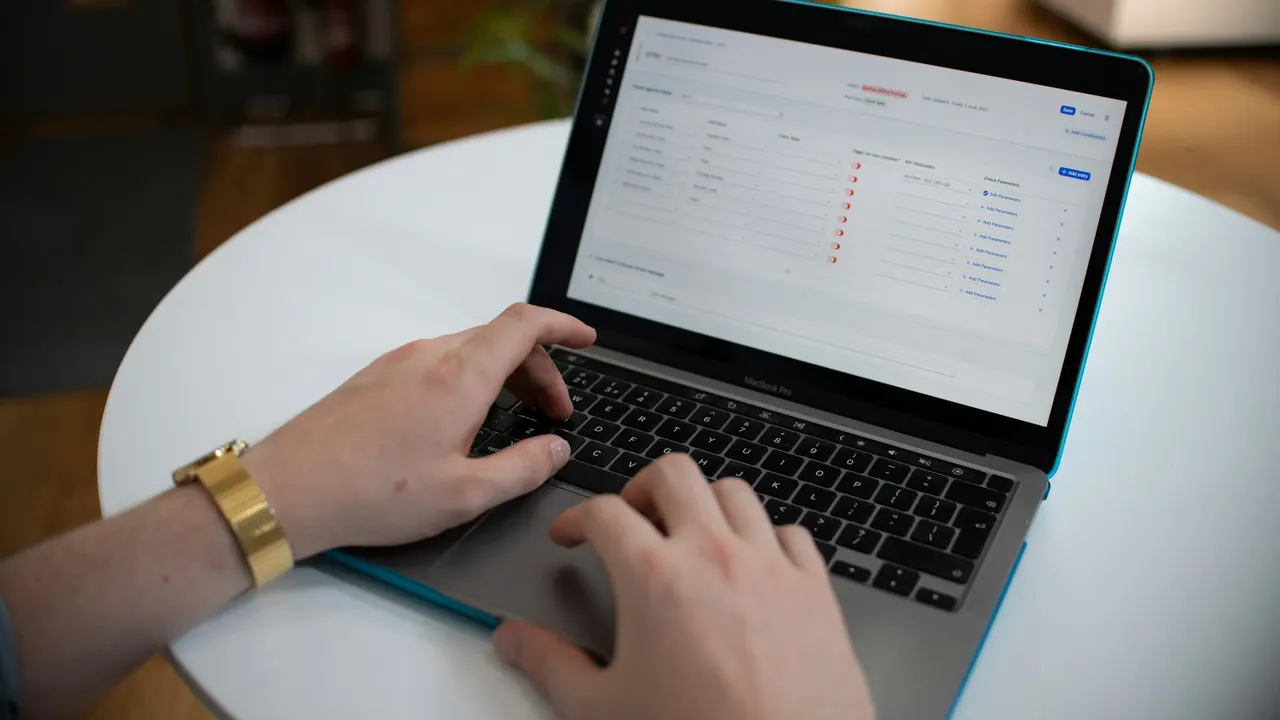 Hands filling in an online form on a laptop